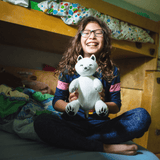 Little Girl Holding Arctic Fox Stuffed Animal Made from Recycled Plastic