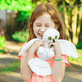 Little Girl Hugging Snowy Owl Stuffed Animal made from Recycled Plastic